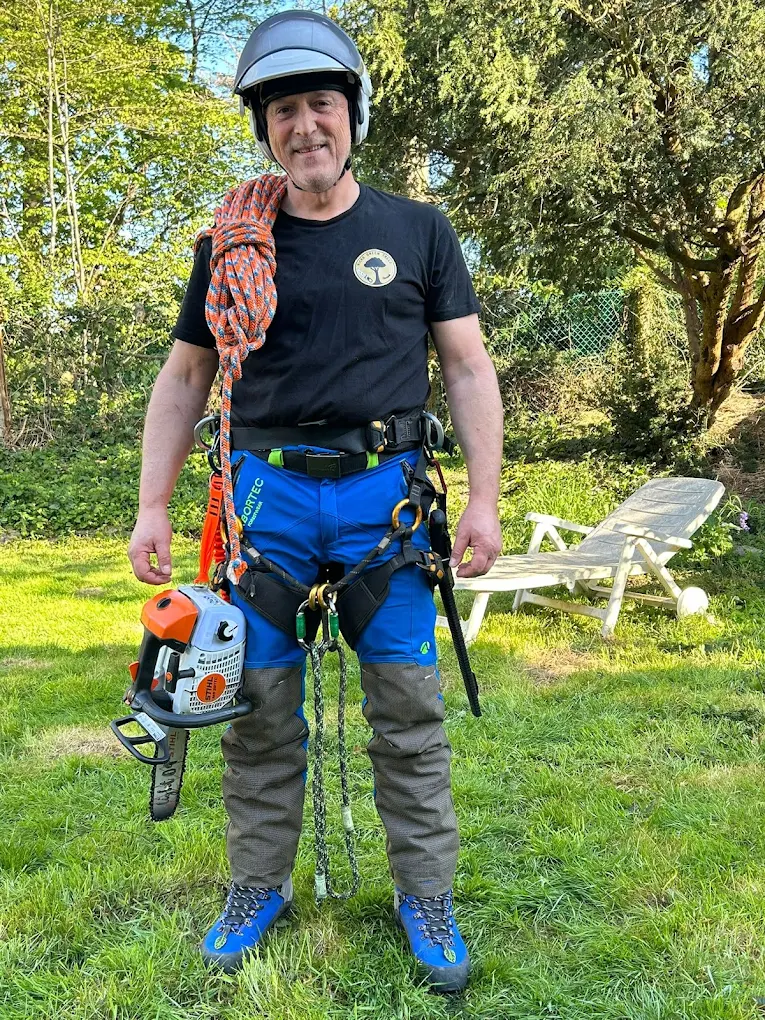 Nick Kaye in climbing harness with helmet, rope and chainsaw